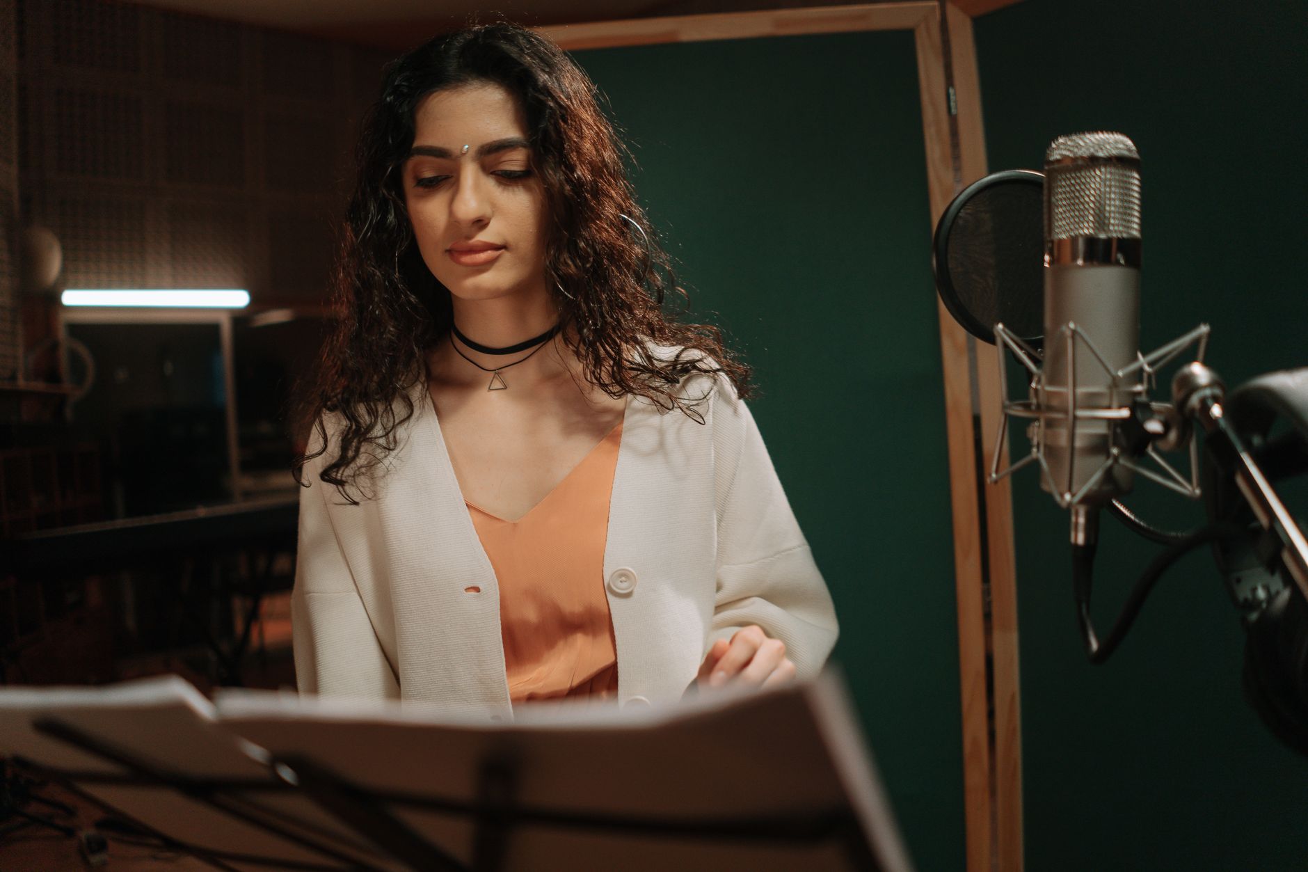 Portrait of a celebrated singer with a microphone, highlighting their musical journey and achievements.