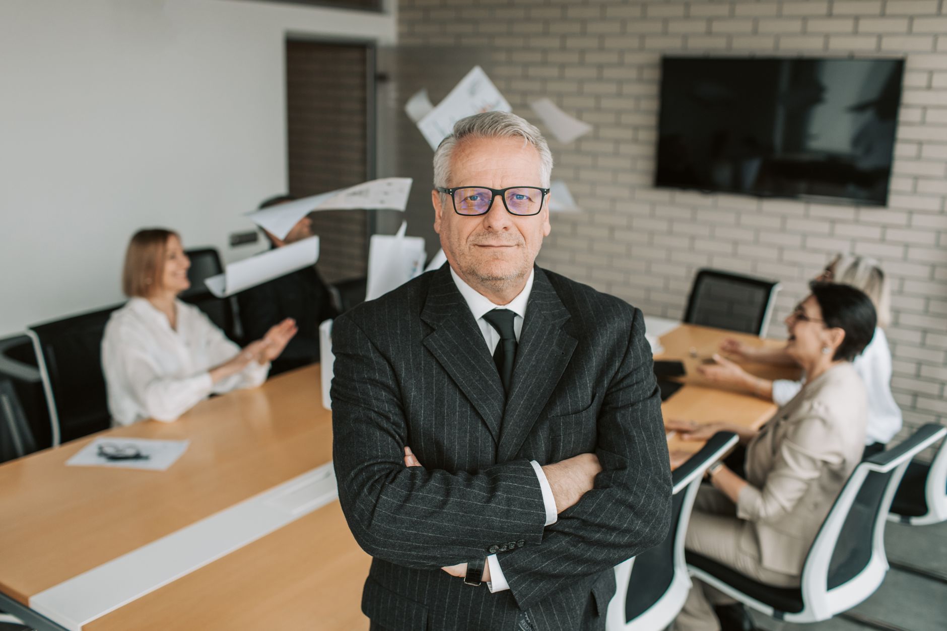 Confident business leaders discussing strategy around a conference table