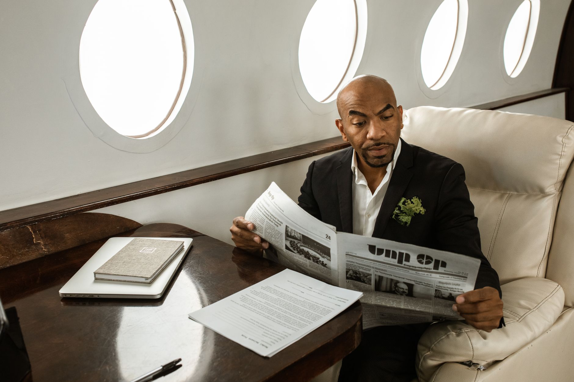 Image of a billionaire entrepreneur reading their own biography, symbolizing success and legacy