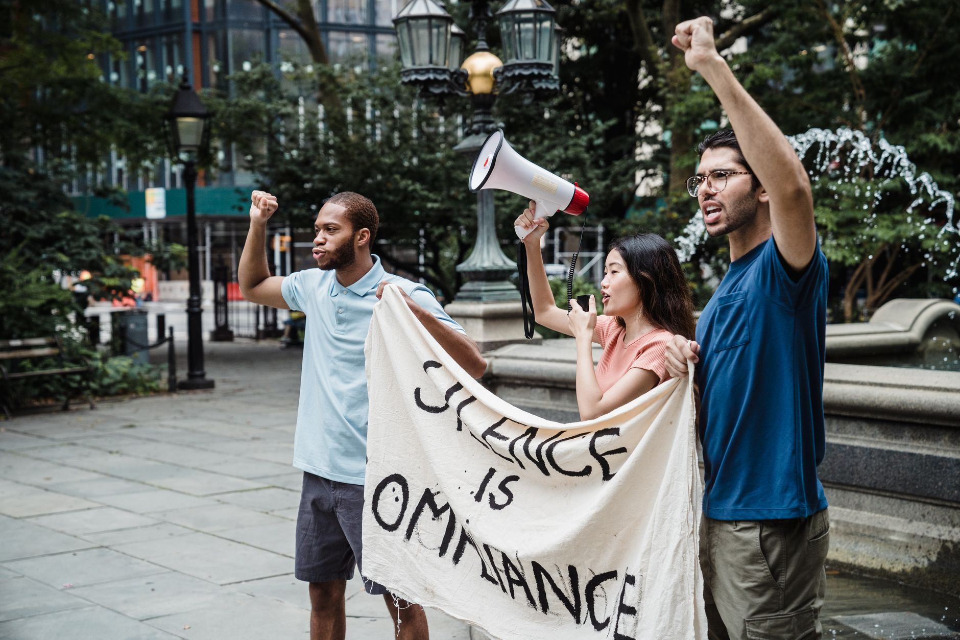 A group of diverse activists marching together, holding signs for climate justice.